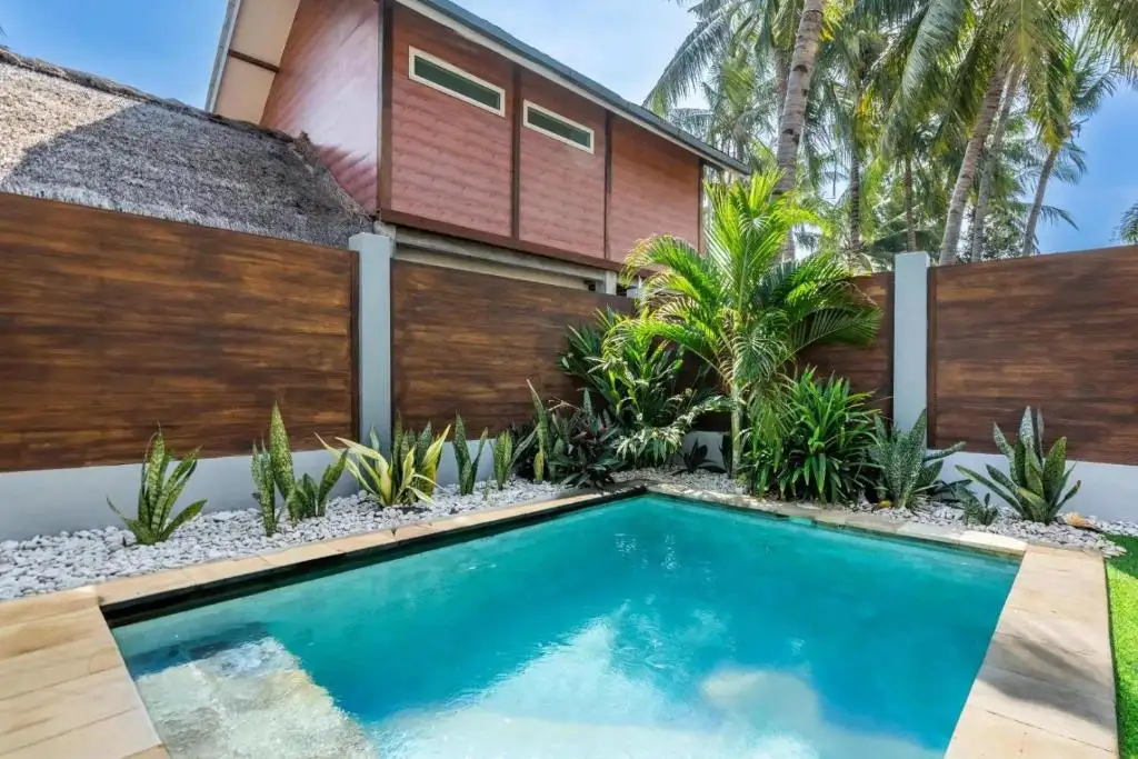 Turquoise pool framed by tropical plants