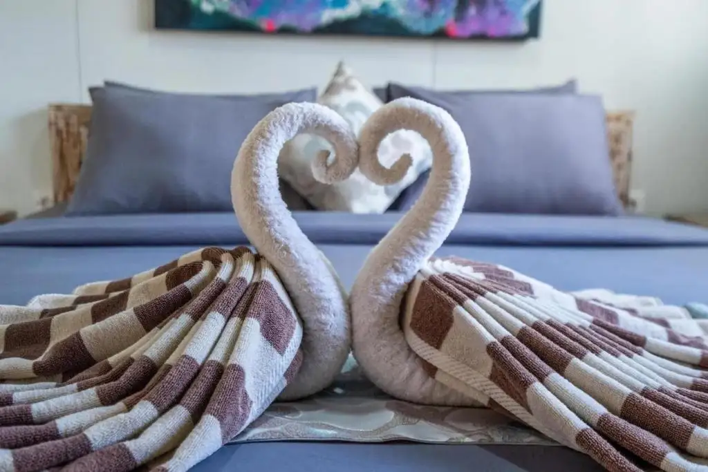 Towel swans welcome on the bed